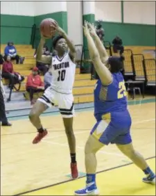  ?? JOHN BLAINE — FOR THE TRENTONIAN ?? Trenton’s Ishuana Hunter (10) puts up a shot over the defense of North Brunswick’s Renee Hales (25) during a Central Group IV playoff game on Monday afternoon.