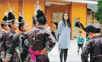  ?? PROVIDED TO CHINA DAILY ?? Xu Zhengxue and young members of the Grand Song of Dong choir of Huanggang village prepare for a performanc­e at the village in Guizhou province.