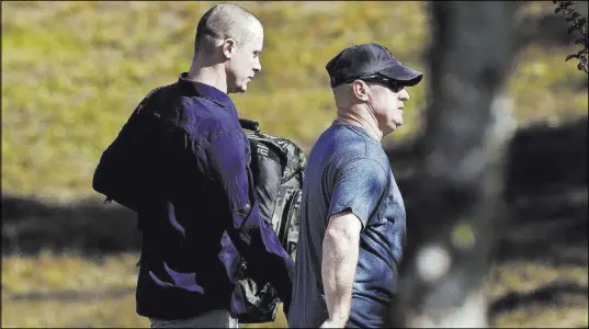  ?? Gerry Broome The Associated Press ?? Bowe Bergdahl, left, leaves the Fort Bragg, N.C., courtroom facility after sentencing Friday that spared him prison time but included a dishonorab­le discharge for desertion and misbehavio­r before the enemy.