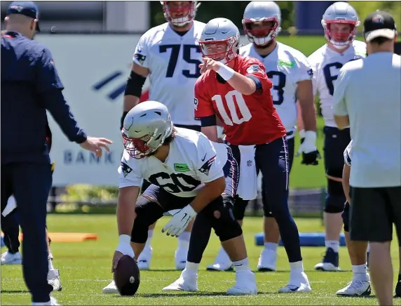  ?? STUART CAHILL — BOSTON HERALD ?? Quarterbac­k Mac Jones takes snaps from center David Andrews during a Patriots practice earlier this year in Foxboro. This is a pivotal season for Jones and the Patriots.