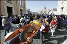  ?? ANDREW MEDICHINI — THE ASSOCIATED PRESS ?? In this photo taken on Saturday members of Amazon indigenous population­s walk during a Via Crucis (Way of the Cross) procession from St. Angelo Castle to the Vatican.