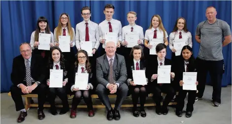  ??  ?? Bronze Duke of Edinburgh award winners from Trinity High School’s S5 and S6 year groups with PE teacher Martin O’Donnell and councillor and head teacher Brian McKenna.