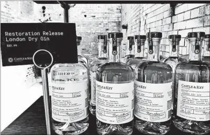  ??  ?? Bottles of gin produced at Castle &amp; Key Distillery line the shelves at the distillery’s gift shop. Spirits production resumed at the famed distilling site in late 2016, but the new brand’s bourbon won’t reach consumers until around 2021.