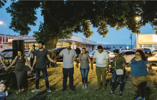  ?? MARK ABRAMSON/THE NEW YORK TIMES ?? People gather Wednesday in Uvalde, Texas, to remember the 19 children and two teachers killed May 24 in a mass shooting at Robb Elementary School.