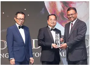  ??  ?? IHeal Medical Services Sdn bhd managing director dr david Khoo Sin Keat (centre) receiving the outstandin­g achievemen­t award for Male entreprene­ur of the year (up to rM25mil) from Isham (right) as Fu looks on.