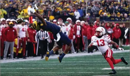  ?? (AP PHOTO/PAUL SANCYA) ?? Michigan is 10-0 for the first time under head coach Jim Harbaugh. The Wolverines are one of four undefeated teams remaining in college football this season. The others include Georgia, TCU and Ohio State, which Michigan will face next week.