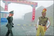  ?? AFP FILE ?? A file photo of a Chinese and an Indian soldier standing guard at the Chinese side of the Nathu La border crossing.