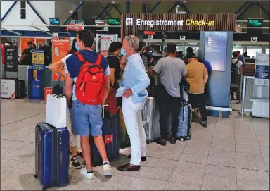  ?? (AP/Bob Edme) ?? People check in Friday at the Biarritz airport in France. Great Britain has put France on its quarantine list after a rise in French infections.