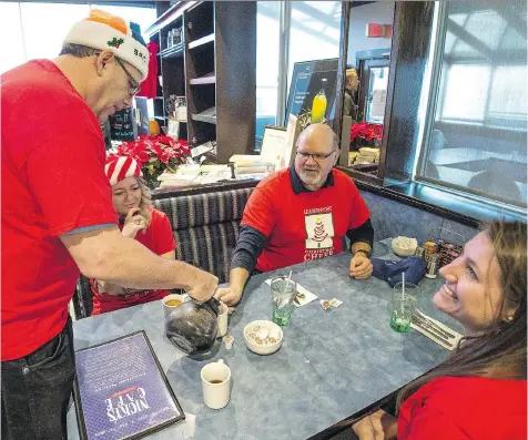  ?? BRANDON HARDER ?? Rob Vanstone, veteran Leader-Post sports writer, pours coffee for colleague Murray McCormick. Leader-Post reporter Ashley Martin can be seen on the right. Between McCormick and Vanstone is Amanda Amberson, who works in the newspaper’s advertisin­g...