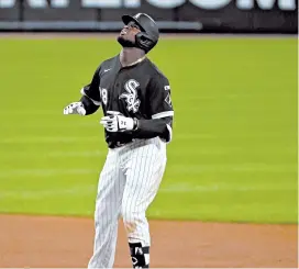  ?? JOHN J. KIM/CHICAGO TRIBUNE ?? Rookies who made big league debuts without family present include Royals pitcher Brady Singer, above, against the Indians on Saturday and the White Sox’s Luis Robert, left, on Friday.