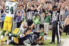  ?? STEPHEN BRASHEAR, AP ?? Replacemen­t officials gave differing signals on the infamous Packers-Seahawks “Fail Mary” play in September 2012.