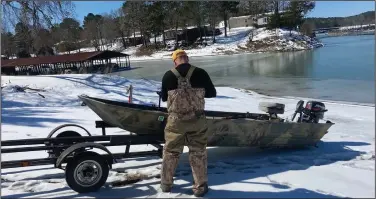  ??  ?? Chris Larson of Maumelle prepares to winch his boat back onto its trailer after a mishap Saturday at Lake Ouachita. (Arkansas Democrat-Gazette/Bryan Hendricks)