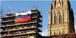  ??  ?? Insult: Russian flag was hung from cathedral scaffoldin­g