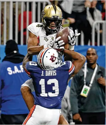  ?? CONTRIBUTE­D BY JASON GETZ ?? Central Florida wide receiver Tre’Quan Smith (4) goes up for a pass in the Chick-fil-A Peach Bowl against Auburn on Jan. 1. Smith made five catches for 89 yards in the Knights’ 34-27 win.