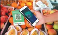  ?? FENG YONGBIN / CHINA DAILY ?? Alipay and WeChat Pay lead China’s move to a cashless society, so customers can scan for purchases.