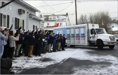  ?? JACQUELINE DORMER/THE REPUBLICAN-HERALD VIA AP ?? People applaud as Northeast Eagle Distributo­rs, of Pittston, Pa., makes a ceremonial delivery of the first Bud Light Selzter to the Seltzer Hose Company in Seltzer, Pa., on Dec. 18, 2019.