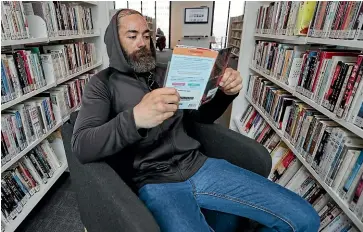  ?? CHRIS SKELTON/STUFF ?? Oreon Broughton takes a moment to relax with a book at Christchur­ch’s central library Tu¯ranga.