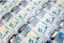  ??  ?? New $10 banknotes are minted prior to their release into public circulatio­n.