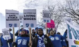  ?? Photograph: Anadolu Agency/ Getty Images ?? Minneapoli­s school teachers hold placards during the strike in front of the Justice Page Middle school in Minneapoli­s, Minnesota, earlier this month.