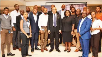  ??  ?? Group Managing Director, FBN Holdings, Urum Eke (middle); and Group Head, Human Capital Management and Developmen­t, Rosie Ebe-arthur, with participan­ts at the induction of new employees in Lagos.