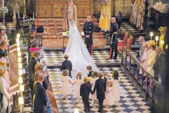  ?? OWEN HUMPHREYS/ASSOCIATED PRESS ?? Meghan Markle reaches the altar during her wedding ceremony with Britain’s Prince Harry at St. George’s Chapel in Windsor Castle, near London, on Saturday.