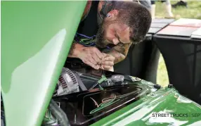  ??  ?? LEFT. GOOCH CUSTOM’SOWN BRANDON MCCOY LAYS DOWN SOME STRIPING ON A DODGE DAKOTA.