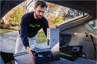  ?? Alejandro A. Alvarez/tribune News Service ?? Naial Casanovas Mack, founder of Dropupp, puts items in his car that a customer left for pickup at their Bryn Mawr, Pa., home last week. Some retailers are hiring employees for returns.