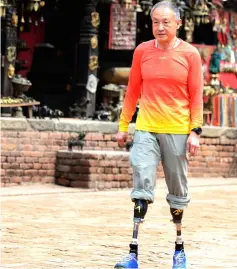  ??  ?? This photograph shows Xia walking in Bhaktapur on the outskirts of Kathmandu, ahead of another attempt to climb the mountain. — AFP photo