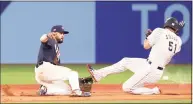  ?? Koji Watanabe / Getty Images ?? Japan’s Seiya Suzuki is tagged out by the United States’ Eddy Alvarez during a steal attempt during the gold-medal game at the Olympics on Saturday.