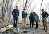  ?? NEW YORK TIMES FILE PHOTO ?? President Donald Trump tours fire-ravaged homes in Paradise, Calif., earlier this month with, from left, Gavin Newsom, the governor-elect; Trump; Gov. Jerry Brown; Jody Jones, the mayor of Paradise; and Brock Long, the FEMA director. Friday’s government report, detailing in stark terms the economic cost of climate change, is likely to be played down by the administra­tion, even as opponents use it to attack Trump policies.