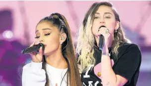  ??  ?? ●●Ariana and Miley Cyrus sing a duet