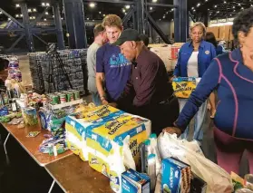  ?? Jeff Syptak / City of Houston ?? Mayor Sylvester Turner visits with volunteers Saturday at the George R. Brown Convention Center, where donations are being collected this weekend.