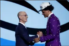  ?? / Getty Images ?? NBA commission­er Adam Silver, left, greets Paolo Banchero after Banchero was drafted with the 1st overall pick by the Orlando Magic on Thursday night at Barclays Center in New York City.