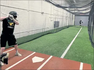  ?? COURTESY OF FITCHBURG STATE BASEBALL ?? The Fitchburg State baseball team takes batting practice at Landry Arena last week. The team is tentativel­y scheduled to open the 2021 season March 26 against MCLA.