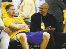  ?? Scott Strazzante / The Chronicle 2015 ?? Mychal Thompson, who played 12 seasons in the NBA, talks with son Klay before a Warriors playoff game in 2015.