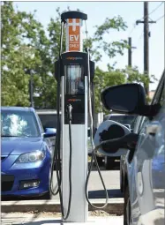  ?? RECORDER PHOTO BY CHIEKO HARA ?? An electric-powered vehicle gets a charge at the city's charging station in the Centennial parking lot.