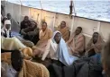  ?? PICTURE: AP ?? ALL AT SEA: Men wait on the deck of the Golfo Azzurro vessel after being rescued on the Mediterran­ean, 32km north of Zuwarah, Libya.