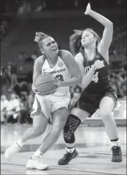  ?? NWA Democrat-Gazette/ANDY SHUPE ?? Arkansas guard Chelsea Dungee (left) drives past Belmont guard Macie Culbertson on Wednesday during the first half at Bud Walton Arena in Fayettevil­le. Visit nwadg.com/photos to see more photograph­s from the game.