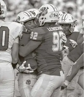  ?? Jerry Baker ?? Katy defensive back Kaden Gonzales, left, gets a hug from teammate Jonah Lebischak after Gonzales recovered a fumble deep in The Woodlands territory in the waning moments of the second quarter Saturday night.