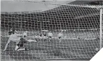  ??  ?? Jim Baxter slots home past Gordon Banks from the penalty spot against England at Wembley in 1963.