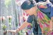  ?? REUTERS FILE ?? A woman touches the name of a family member on a memorial to victims of Air India Flight 182 on the Toronto waterfront.