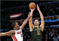  ?? AP Photo/Ringo H.W. Chiu ?? ■ Los Angeles Lakers center Brook Lopez shoots over Miami Heat center Bam Adebayo on March 16 in Los Angeles. Entering the Bucks’ game against Memphis on Wednesday night, Lopez was tied for seventh in the league in made 3’s (39) and was 14th in attempts (93), shooting 41.9 percent from behind the arc.