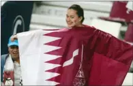  ??  ?? A fan celebrates with the Qatar flag at the Khalifa Intl Stadium.