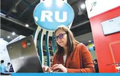  ??  ?? MOSCOW: A woman uses a laptop under the “.ru” domain zone sign during the 10th Russian Internet Week in Moscow yesterday.