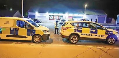  ??  ?? ●● Police seal off the area around the shop on Albert Royds Street