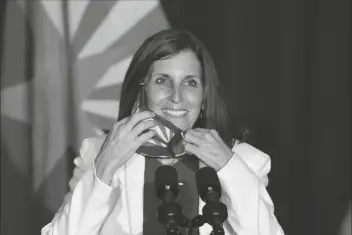  ?? ASSOCIATED PRESS ?? SEN. MARTHA MCSALLY, R-ARIZ., smiles as she removes her face covering to speak prior to Vice President Mike Pence arriving Aug. 11 to speak at the “Latter-Day Saints for Trump” coalition launch event in Mesa.