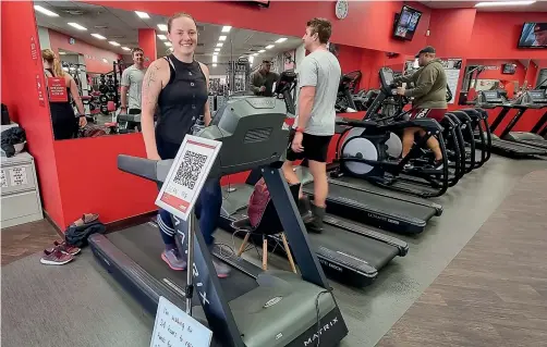  ?? YASHAS SRINIVASA/STUFF ?? Lily Muir, 29, left, is walking for 24 hours at Snap Fitness, Timaru, to raise funds for her injured father.