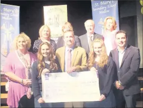  ??  ?? St. Mary's students Claudia O'Donoghue and Emily Fitzpatric­k presenting their cheque to the value of ¤5,450 to Tom McIvoy from Pieta House. Also included are Cllr John Paul O'Shea, Principal Yvonne Bane, Eamonn Horgan and St. Mary's staff members...