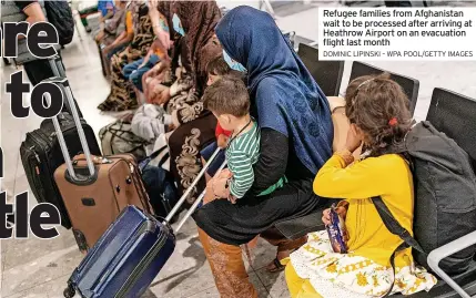  ?? DOMINIC LIPINSKI – WPA POOL/GETTY IMAGES ?? Refugee families from Afghanista­n wait to be processed after arriving at Heathrow Airport on an evacuation flight last month