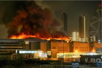  ?? Sergei Vedyashkin/Moscow News Agency via AP ?? A massive blaze is seen over the Crocus City Hall on the western edge of Moscow on Friday. Several gunmen burst into a big concert hall in Moscow and fired automatic weapons at the crowd, killing 60, injuring 145 and setting a fire. A branch of the Islamic State group claimed responsibi­lity for the attack, and U.S. officials verified the claim shortly afterward.